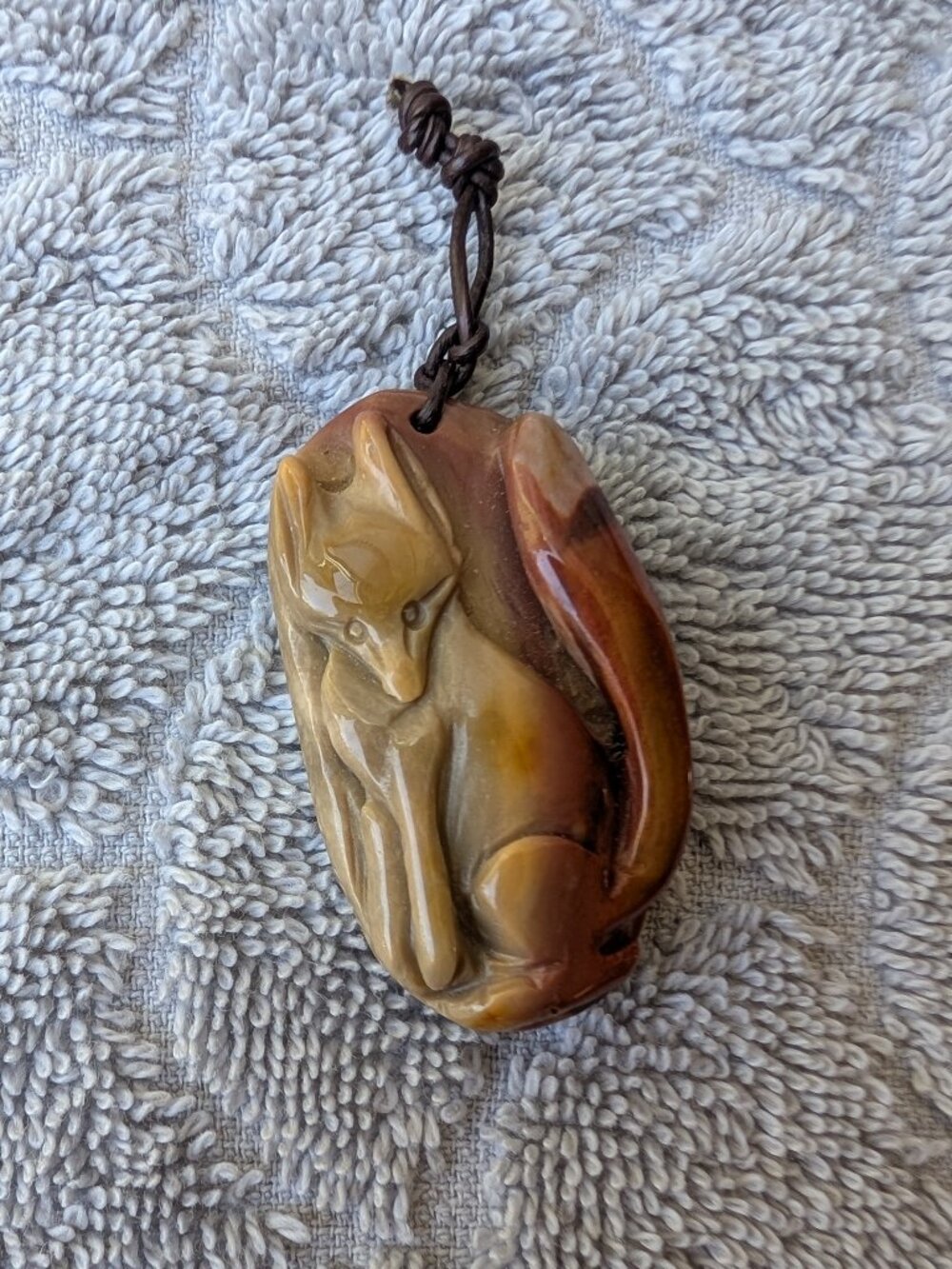 Carved stone Fox pendant with leather bail Carmel colors